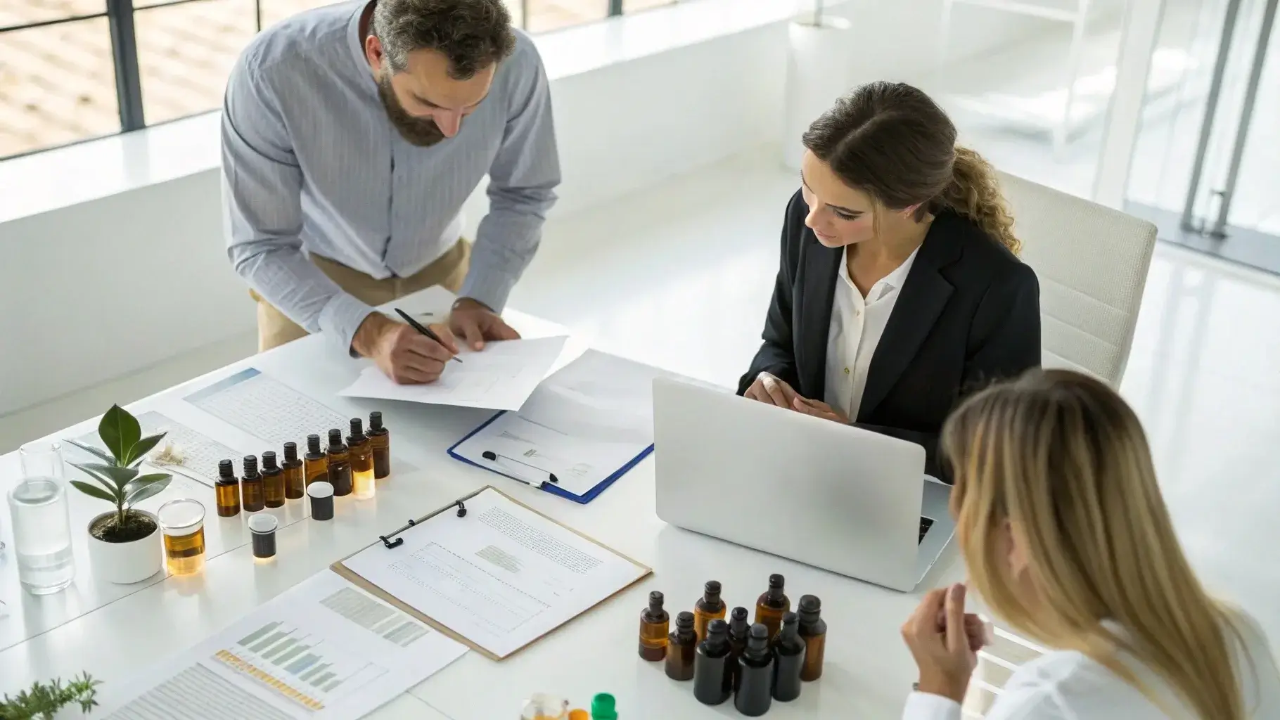 Essential oil sourcing, buyers reviewing oil samples and certificates